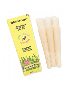 Pack of six Bloomer 1 1/4 Unbleached Pre-Rolled Cones with unique wildflower-blooming filter tips, symbolizing eco-concious smoking.